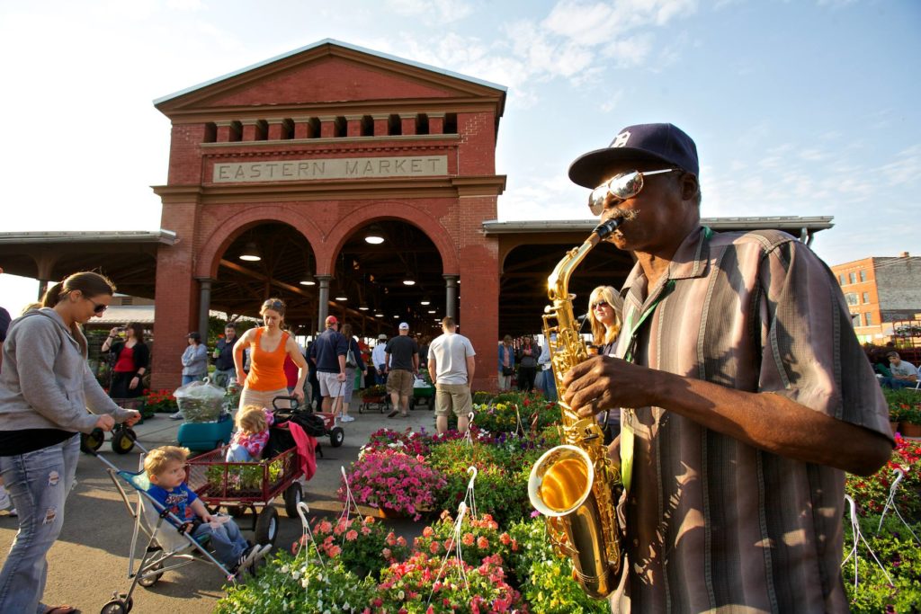 eastern market building with street performer